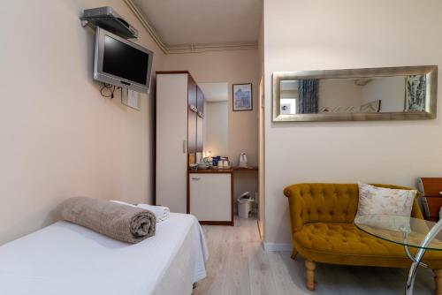 a room with a bed and a chair and a mirror at Villa Bakica in Trogir