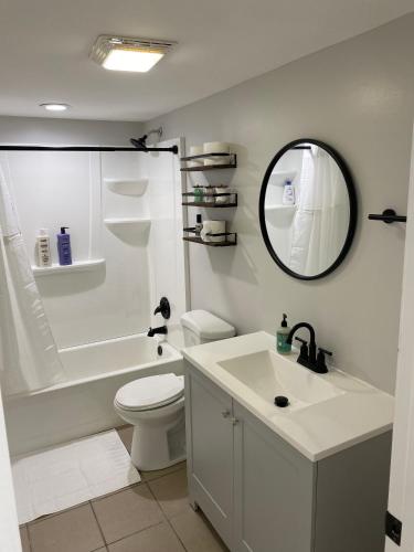 a bathroom with a sink and a toilet and a mirror at Stylish Urban Retreat 3 Bedroom Newly Remodeled in Chicago