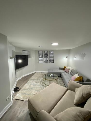 a living room with a couch and a tv at Stylish Urban Retreat 3 Bedroom Newly Remodeled in Chicago