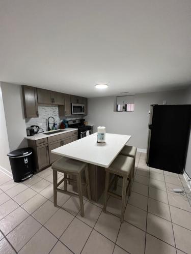 a kitchen with a white table and chairs in it at Stylish Urban Retreat 3 Bedroom Newly Remodeled in Chicago