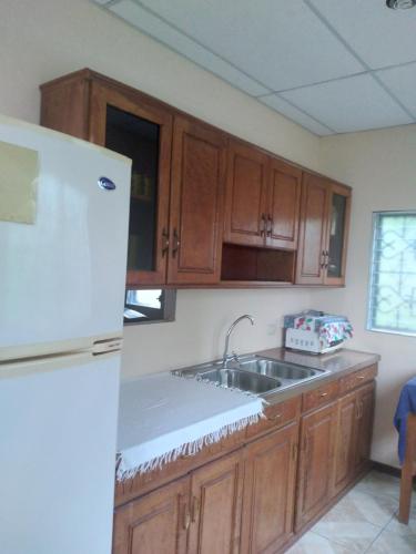 a kitchen with a white refrigerator and a sink at Casa Gonzalez 