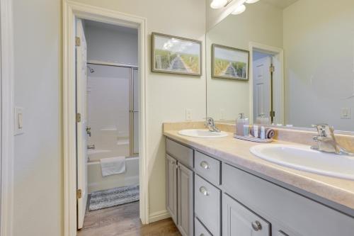 a bathroom with two sinks and a large mirror at Mesquite Vacation Rental Condo with Resort Amenities in Mesquite
