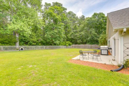 a patio with a table and chairs in a yard at Swansboro Vacation Rental, 4 Mi to Hammocks Beach! in Swansboro
