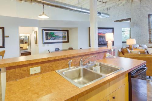 a kitchen with a sink and a living room at Pet-Friendly Billings Vacation Rental in Downtown! in Billings