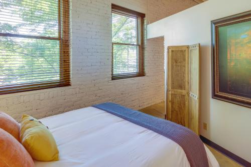 a bedroom with a bed and two windows at Pet-Friendly Billings Vacation Rental in Downtown! in Billings