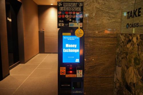 a pay phone in a room with a wall at La Vista Tokyo Bay in Tokyo