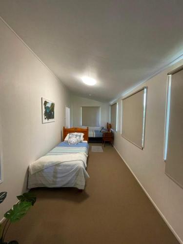 a bedroom with a bed in a room at Keppel Cottage - 7 Limpus Avenue Keppel Sands in Keppel Sands