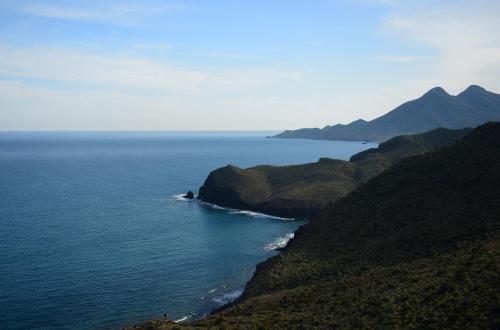 an aerial view of the ocean and a mountain at Hotel Calachica Las Negras in Las Negras
