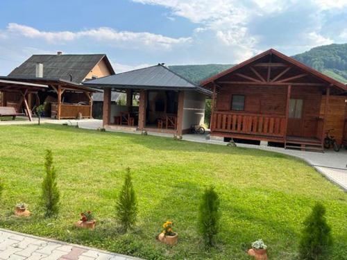a house with a green yard in front of it at Kincses Panzió in Praid