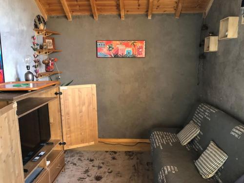 a living room with a couch and a tv at Comme à la maison à la montagne in Briançon