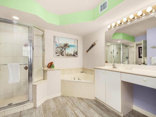 a bathroom with a tub and a sink and a shower at Lovers Key Resort 601 in Fort Myers Beach