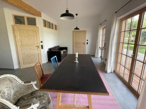 a dining room with a black table and chairs at Das Waschhaus in Mehring