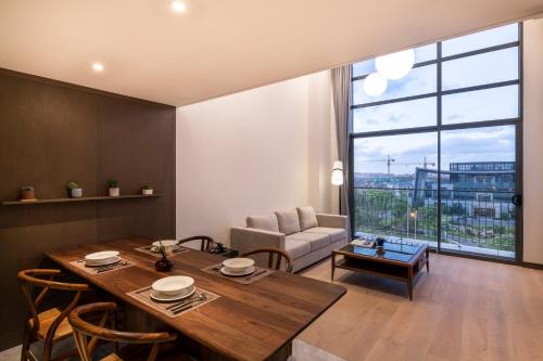 a living room with a table and a couch at Novotel Suites Shanghai Hongqiao in Shanghai