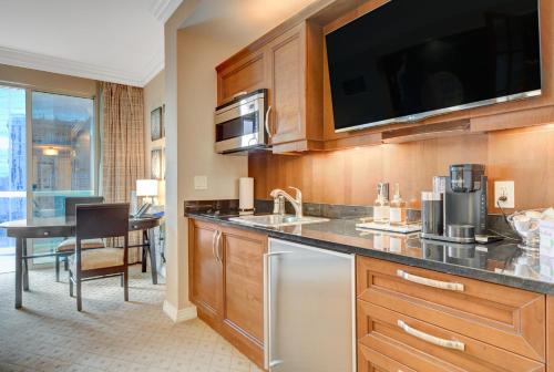 a kitchen with a sink and a microwave at Premium Suite MGM Signature HIGH FLR Balcony Strip View in Las Vegas