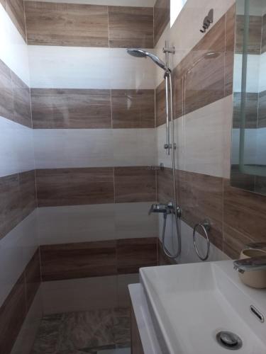 a bathroom with a shower and a sink at En-suite Rooms in shared appartment in Quatre Bornes