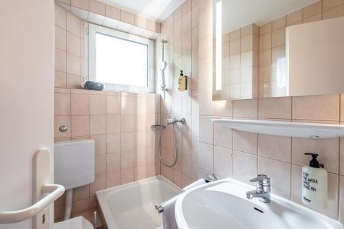 a bathroom with a sink and a bath tub at stuub hinterzarten in Hinterzarten