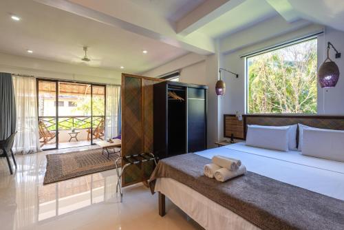 a bedroom with a large bed and a balcony at Kalipay Resort Siargao in General Luna