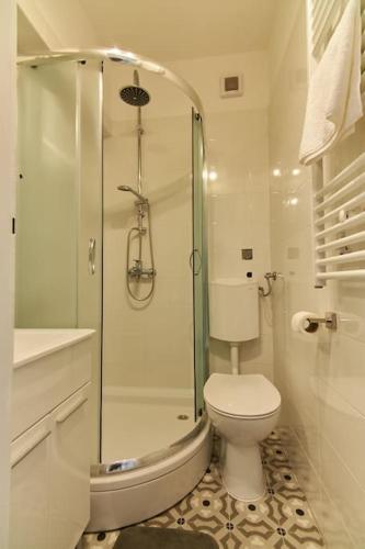 a white bathroom with a toilet and a shower at Apartment Bigeste - free parking - 2 minute walk to the beach - superfast wifi in Opatija