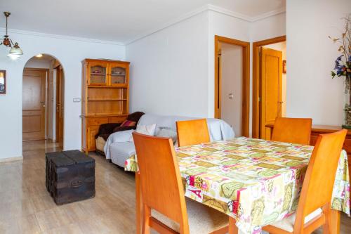 a dining room with a table and a bed at Apolo66-3 in Torrevieja