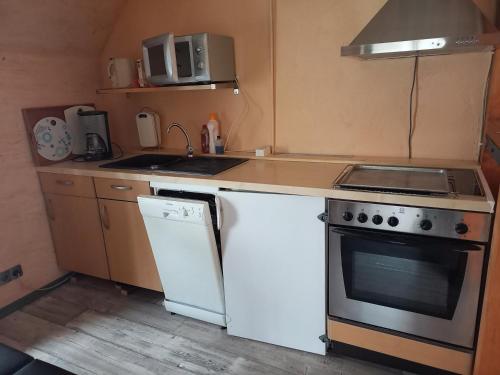 a small kitchen with a stove and a sink at Walla 6 in Lippoldsberg