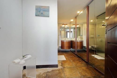 a bathroom with glass shower doors and a tile floor at Super Attico con terrazza Lodi in Rome