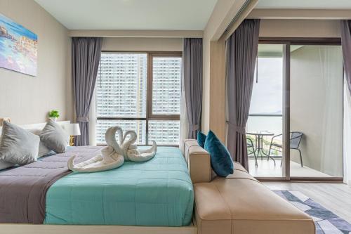 a bedroom with a bed with two shoes on it at Aeras beachfront 1 bedroom in Jomtien Beach
