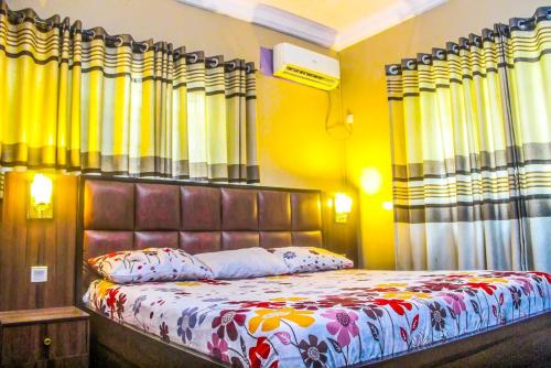 a bedroom with a large bed with aintendent at Juicebox B&B in Lagos