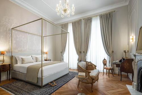 a bedroom with a bed and a chandelier at MS Collection Aveiro - Palacete Valdemouro in Aveiro