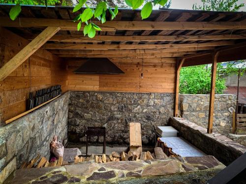 an outdoor kitchen with a stone wall at Family hotel mountain panorama in Borjomi