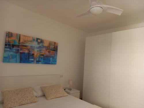 a bedroom with a ceiling fan and a bed at Aura Apartments - Orizzonte Turismo in Porto Cesareo