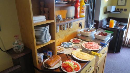 a kitchen with plates and food on a counter at Pension Jana - Wellness in Jilemnice