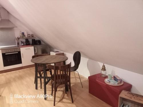 a kitchen with a table and chairs in a room at Um Burebierg apartment 35m2 in Buschrodt