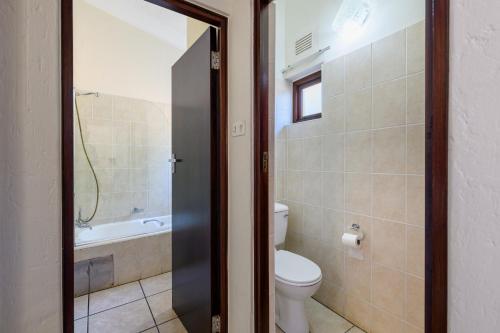 y baño con aseo y bañera. en San Lameer Villa 3501 - 2 Bedroom Classic - 4 pax - San Lameer Rental Agency, en Southbroom