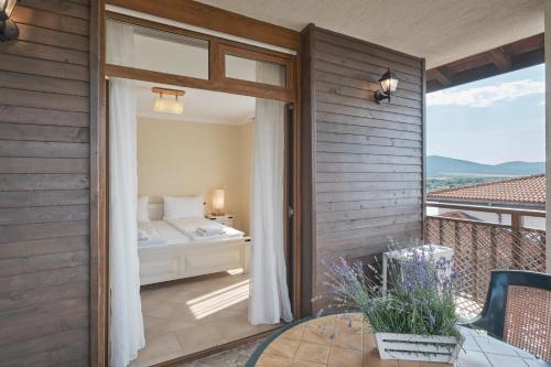 a bedroom with a bed and a balcony at Santa Marina Holiday Village in Sozopol