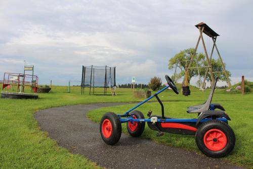 a seesaw vehicle parked next to a playground at Langs Wirtshaus in Sankt Ulrich im Mühlkreis