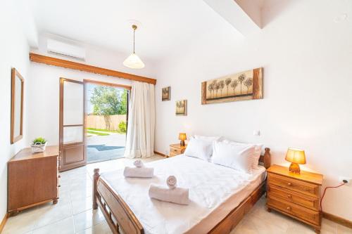 a bedroom with a large bed and a window at Apartment corfu in Lefkímmi