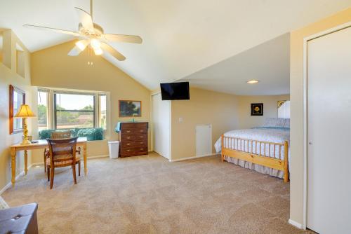 a bedroom with a bed and a desk and a ceiling fan at Prescott Home with Views - Pets Welcome! in Prescott