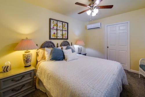 a bedroom with a bed and a ceiling fan at Sunny California Retreat with Pool Access and Patio! in Shasta Lake