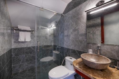 uma casa de banho com um lavatório, um WC e um chuveiro em RAON Hoi An - STAY 24H em Hoi An