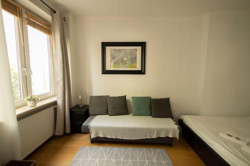 a small room with a bed and a window at Przytulne mieszkanie na ulicy Chmielna w samym centrum Warszawy in Warsaw