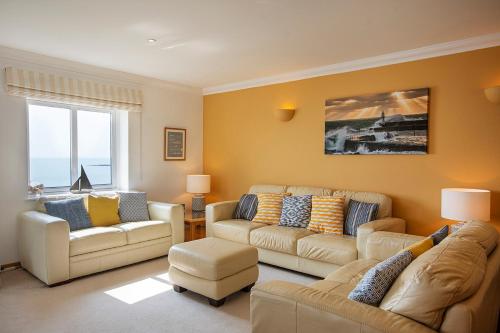 a living room with two couches and a couch at Marine Point, panoramic stunning sea views - balcony & parking in Mevagissey