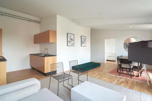 a living room with a couch and a table at Cozy and Bright Apartments with Private Car Park in Copenhagen