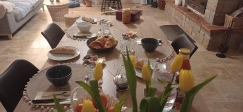 een tafel met eten in de woonkamer bij Sous le Tilleul in Saint-Maurice-de-Cazevieille
