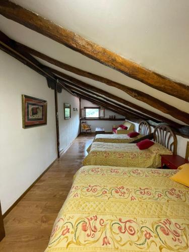 a room with four beds in a attic at La Casa de Sabina in Lon