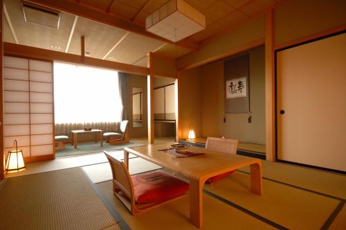 - un salon avec une table et une chaise dans l'établissement Sakaeya Hotel, à Tendō