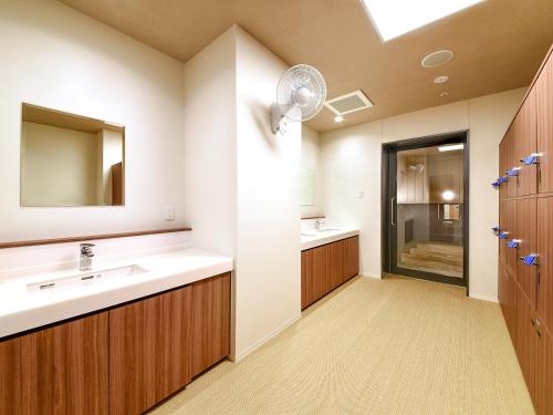 a bathroom with a sink and a mirror at Hotel Livemax Premium Nagano Ekimae in Nagano