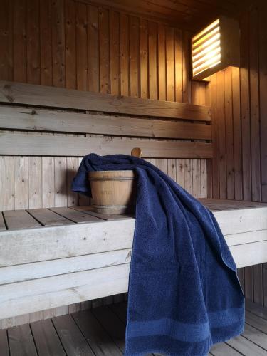 a blue blanket is sitting in a sauna at Sjølund house in Dragøya