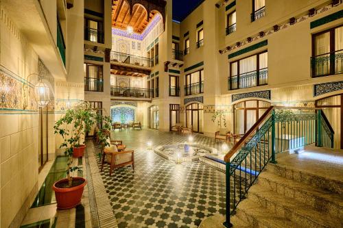 a lobby of a building with a pool in the middle at Kosh Havuz boutique hotel in Samarkand