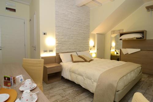 a bedroom with a large bed and a living room at Pidkova in Modena