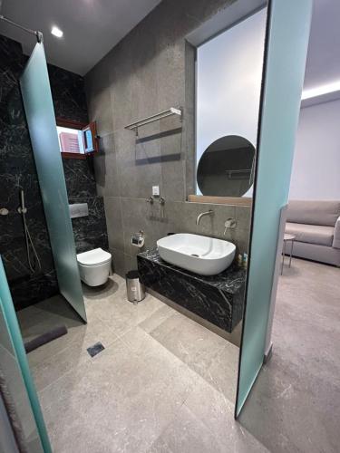 y baño con lavabo y espejo. en HOTEL BARA en Néos Marmarás